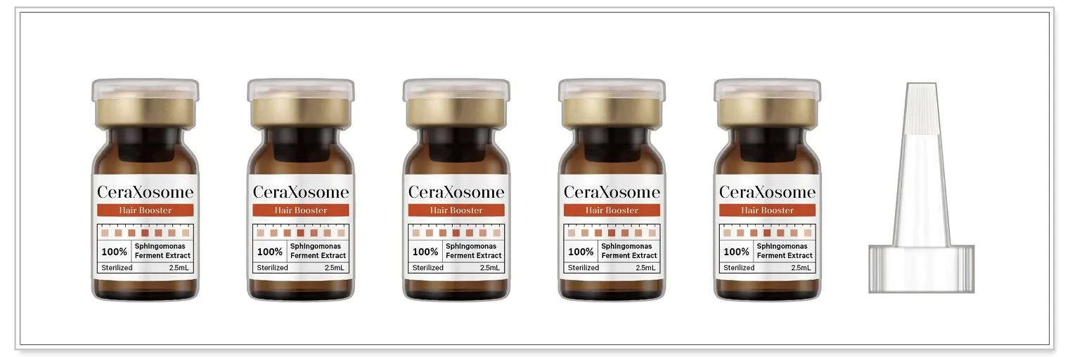 CeraXosome vials with gold caps arranged beside their packaging.