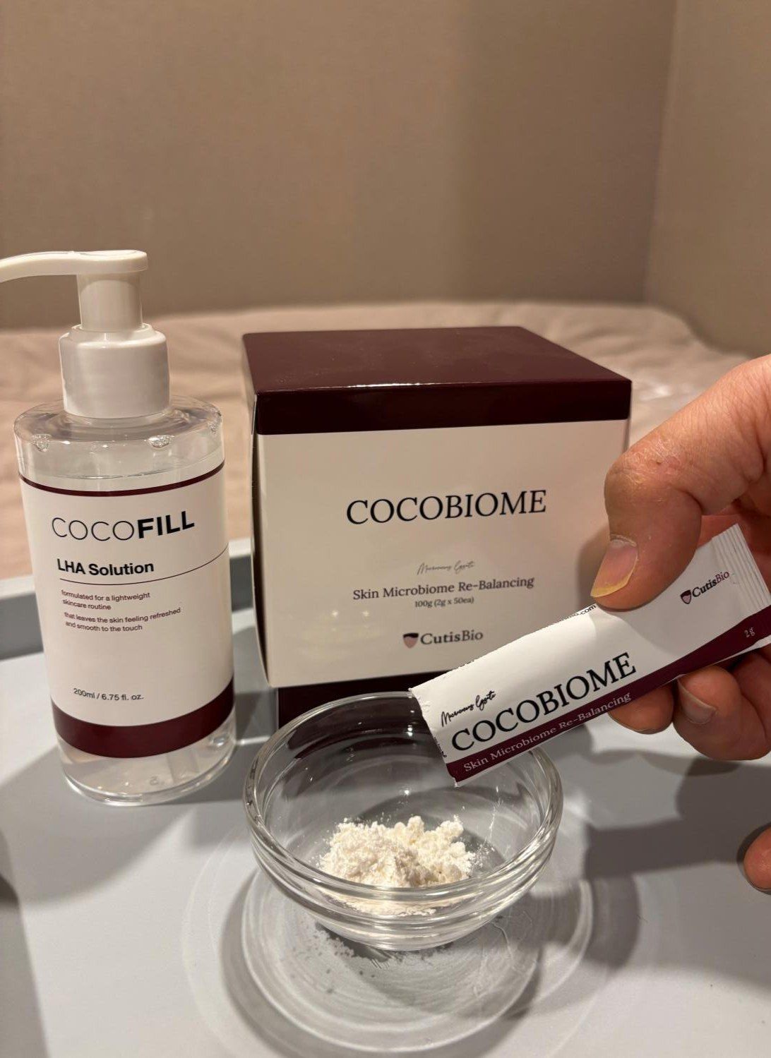CocoFILL components: CocoBiome box and powder sachet, LHA solution pump bottle and glass bowl